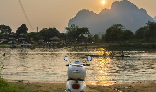 Cover Riding a two-wheeled vehicle to open a Singha in the city of Laos......