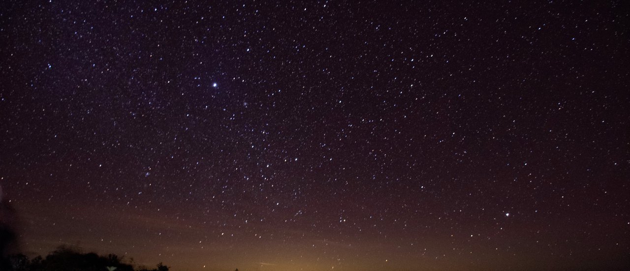 cover Embark on a journey to embrace the cool breeze and breathtaking views of the Milky Way from the peak of Khao San Nok Wua in Kanchanaburi.