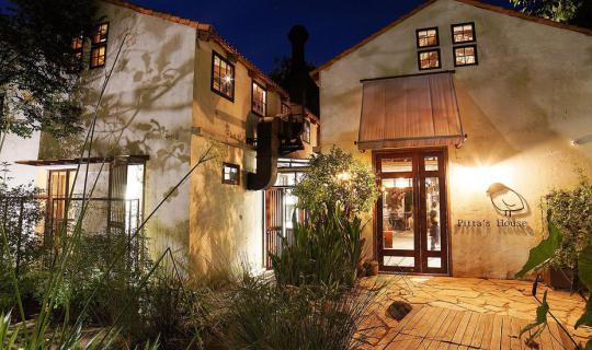 cover A must-visit restaurant, Pitta's house, seamlessly blends into the natural surroundings, offering a delightful dining and coffee experience.