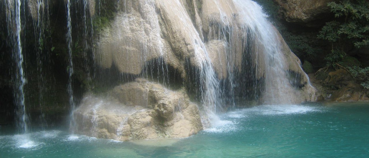 cover UNSEEN Lamphun: Pay respects at Phra That Hariphunchai, admire the stunning Wat San Pa Yang Luang (ranked among the most beautiful temples in Thailand), and have fun splashing around in the refreshing, emerald-green waters of Ko Luang Waterfall!