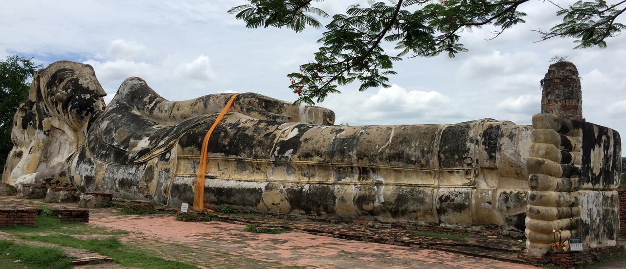 cover Wearing Thai silk to pay respects to the Reclining Buddha.