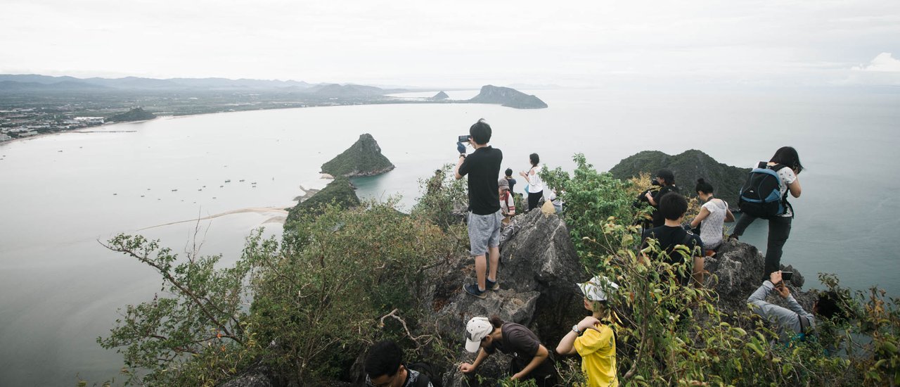 cover Driven by a desire to conquer the summit of "Khao Lom Mow" at least once.