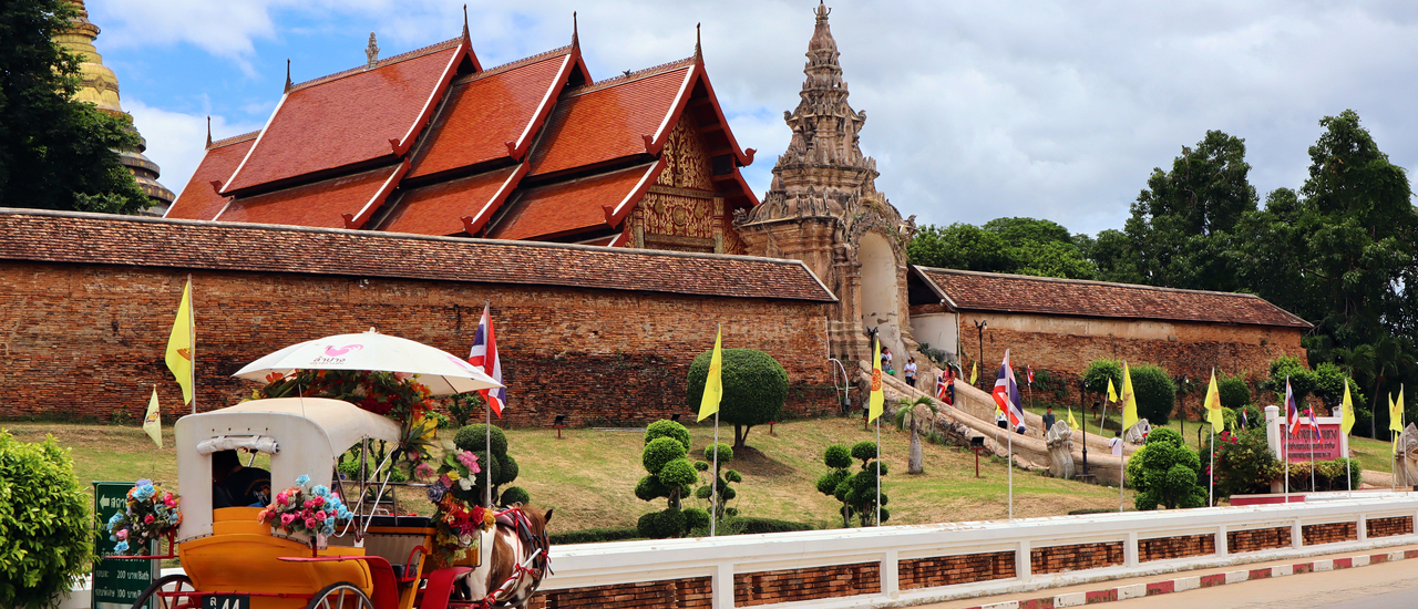 cover Riding a horse carriage to pay respects at Phra That Lampang Luang, Lampang Province.