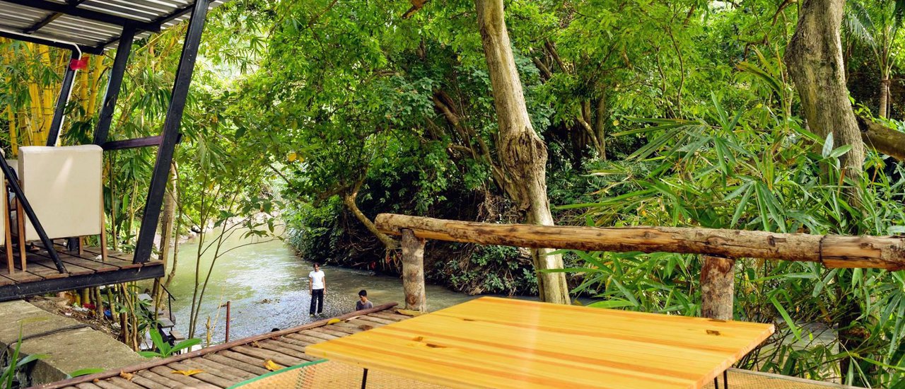 cover Scenic Viewpoint with Dangling Feet Over a Stream at Baan Khao Kod, Lansaka