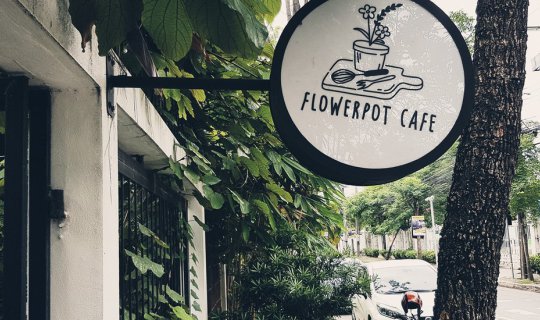 Cover Flowerpot Cafe, a cake shop nestled in a verdant green space....
