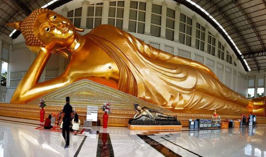 Cover Pay homage to the 55-meter-long reclining Buddha at Wat Sukhumaram i...