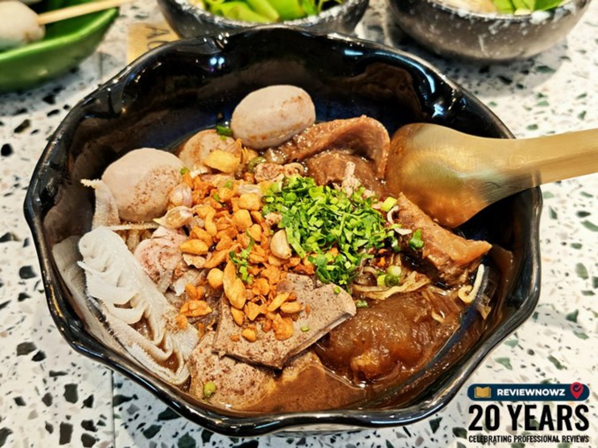 บะหมี่น้ำตกเนื้อตุ๋นเครื่องใน จัดวางเครื่องเคราและน้ำซุปขลุกขลิกอย่างสวยงามในชามเซรามิกสีดำ ร้านก๋วยเตี๋ยวเรือทองสมิทธ์ สาขาพาร์คสีลม ReviewNowz